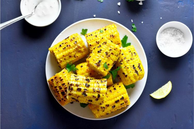 A plate with pieces of grilled sweet corn.