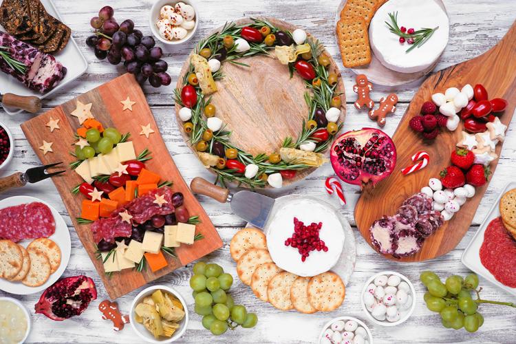 Christmas charcuterie table scene over a white wood background.