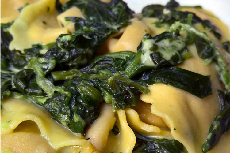 Ravioli with spinach sauce.
