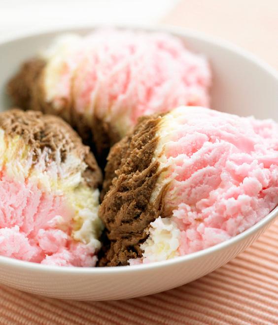 Three scoops of strawberry, vanilla and chocolate ice cream.