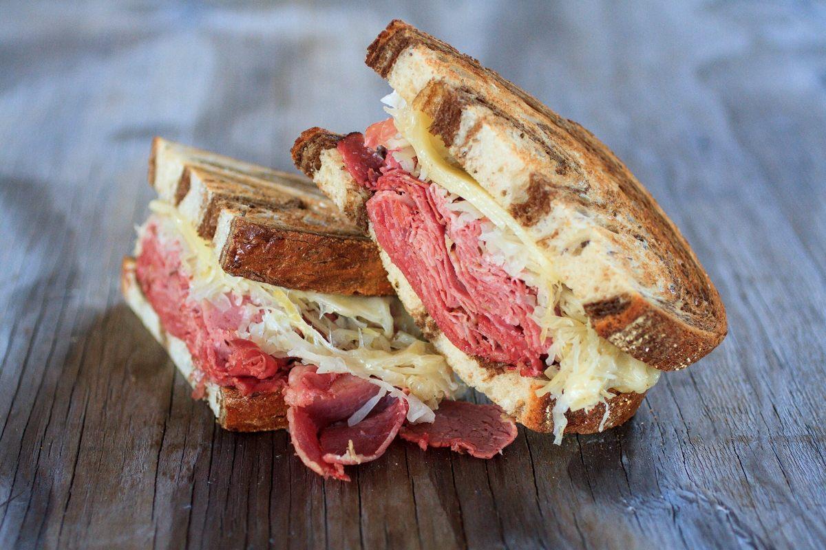 A Reuben sandwich halved.
