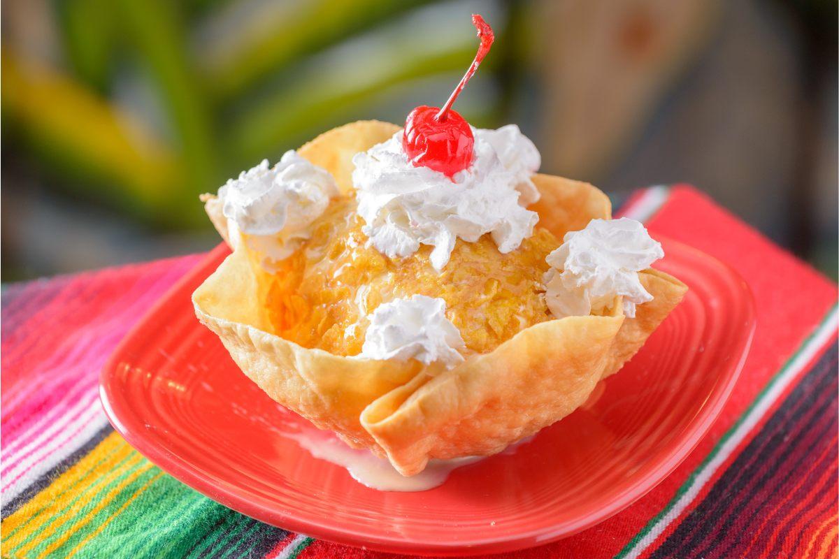 A biscuit container wiht fried ice cream.