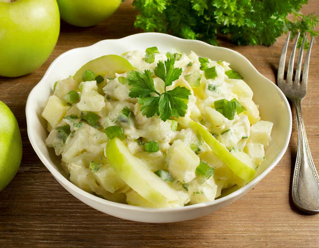 A bowl with Irish potato salad with apples.