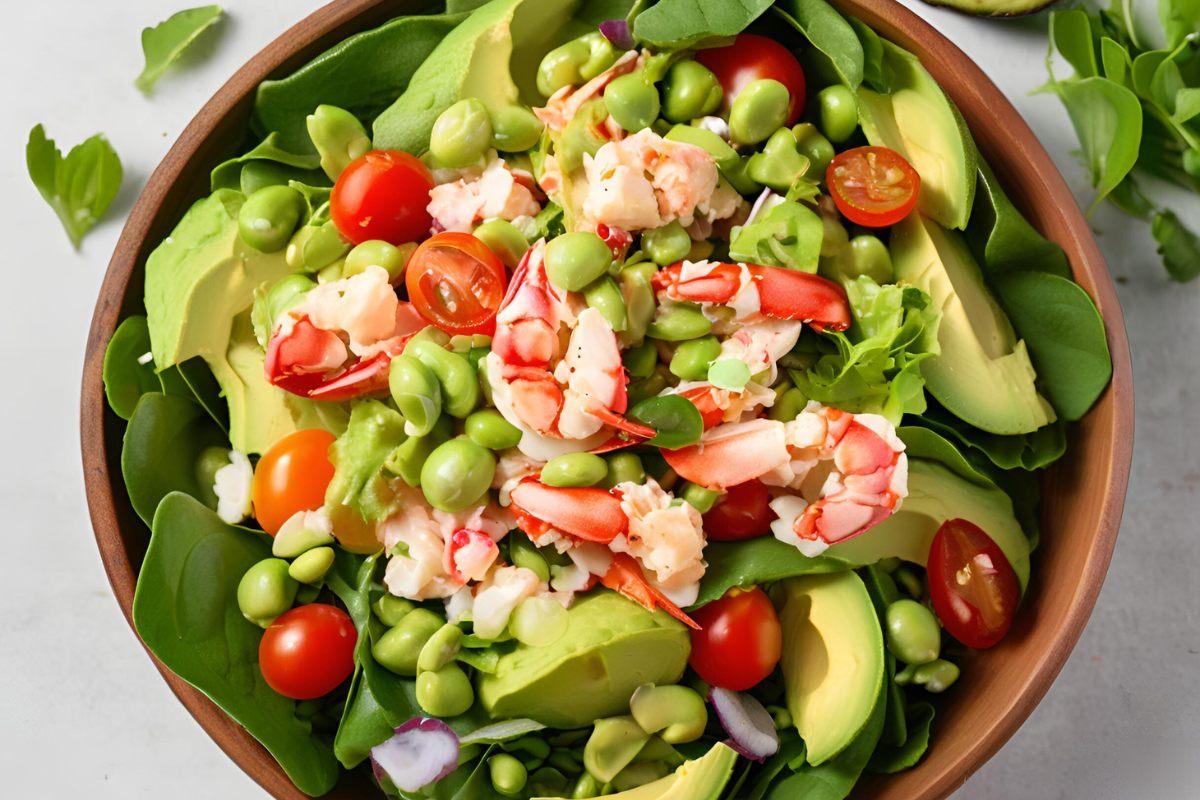 A large bowl with balmain bug, avocado and edamame salad with cherry tomatoes and salad leaves.