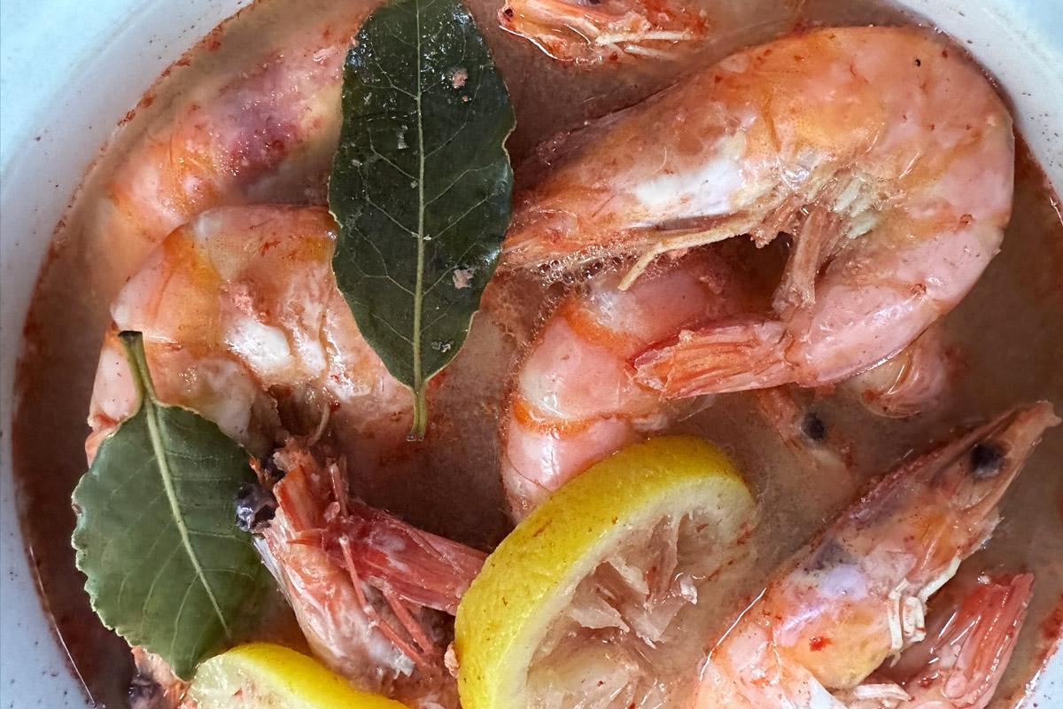 Shell-on shrimp simmeried in beer with bay leaves and lemon slices.