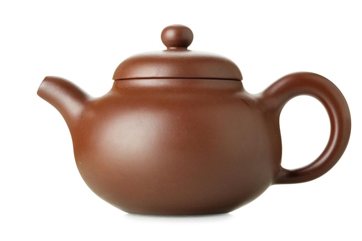 Traditional Yixing clay teapot with round body, curved spout, and lid.