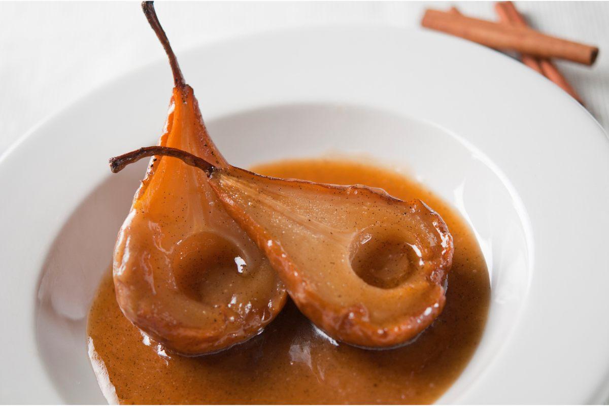 Two poached pears with maple syrup.
