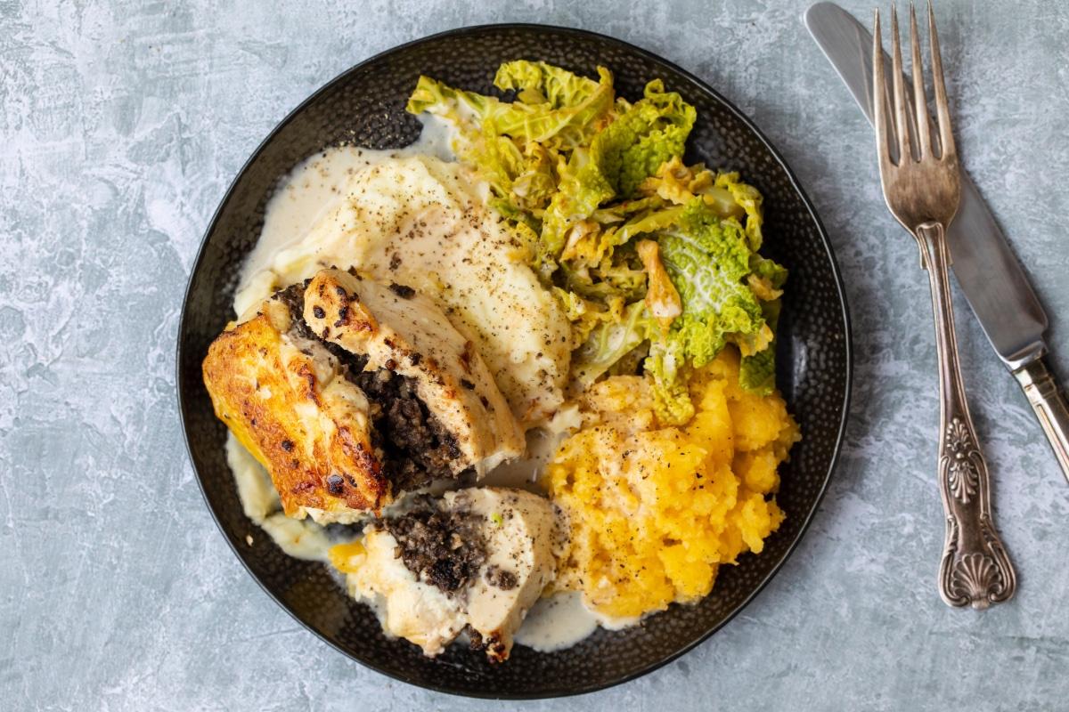A plate of chicken Balmoral with cabbage, neeps and tatties.