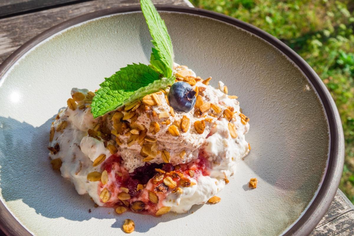 Cranachan in a deep dish decorated with mint leaves. 