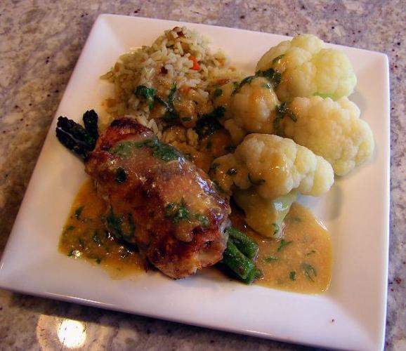 Meat, rice and coliflower on a plate