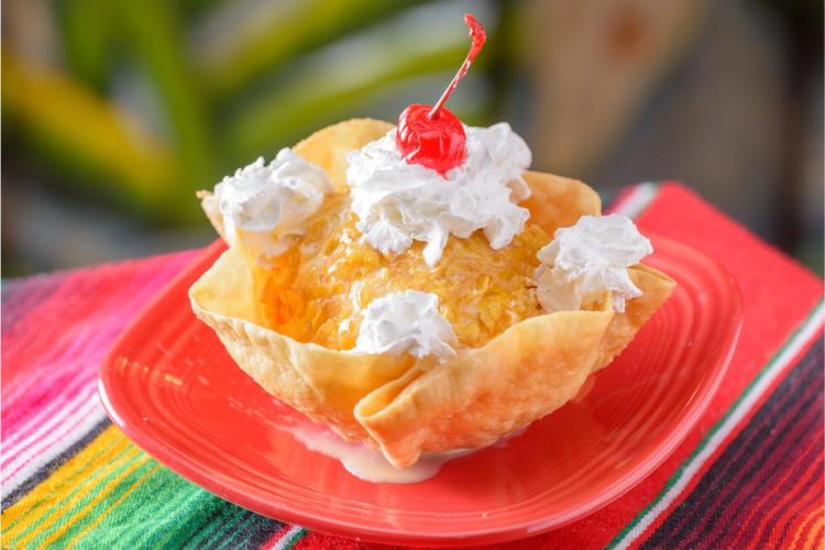 A biscuit container wiht fried ice cream.
