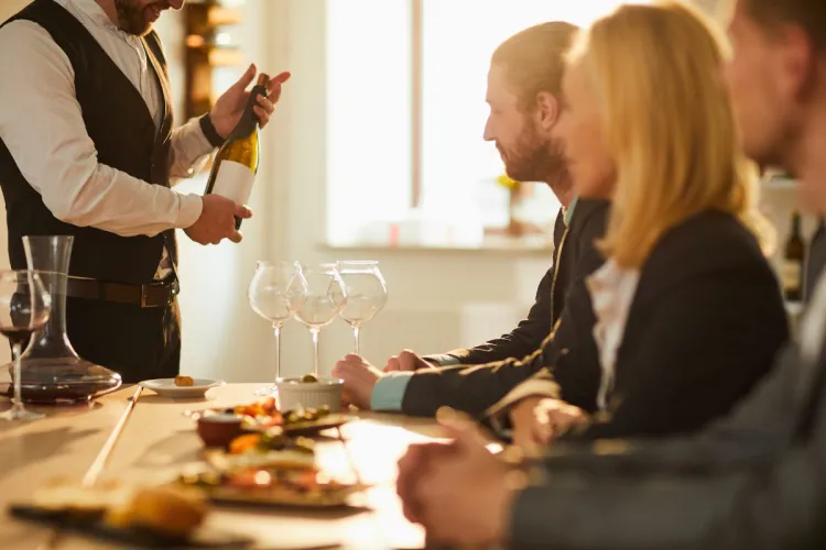 A sommelier presenting wine to a group of people during a wine tour.