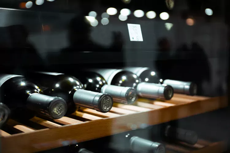 A wine cooler with some bottles of wine.