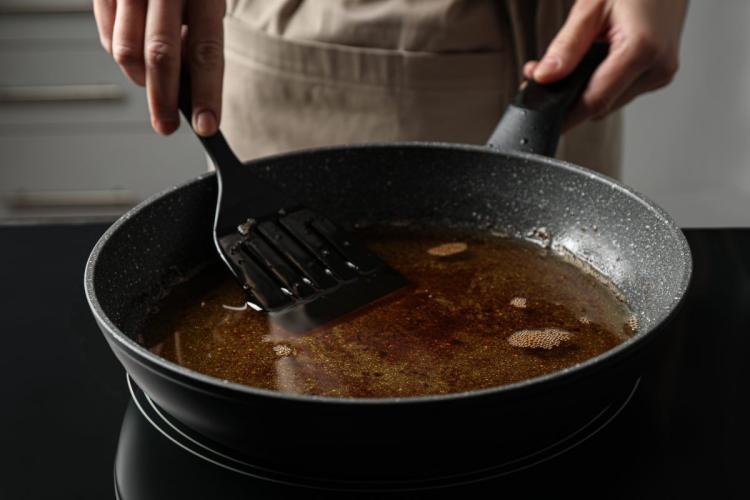 Chef cooking with used cooking oil.