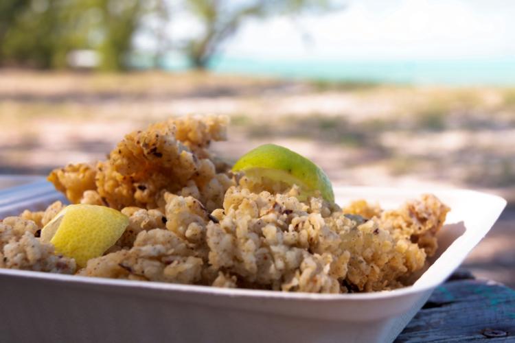 A container filled with cracked conch, a tasty seafood dish.