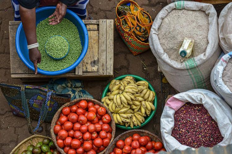 Woman selling food in Huye market, Rwanda.