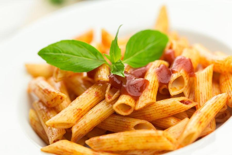Chorizo and tomato penne in a deep dish.
