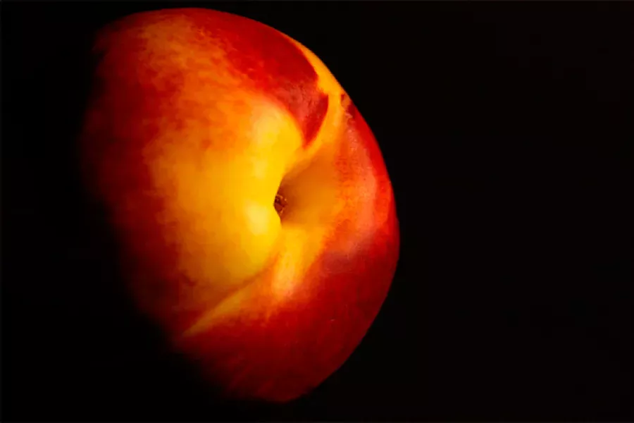 One peach with dark background.