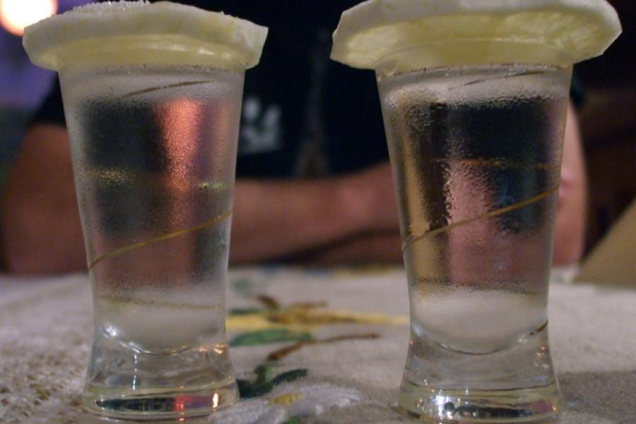 Glasses of vodka with a slice of lemon on top.