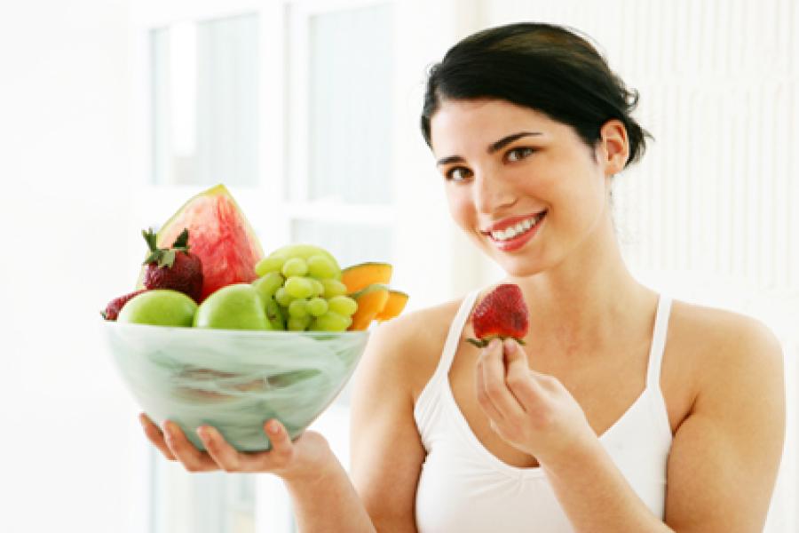 Woman with fruit bowl.