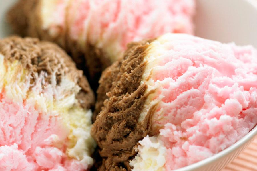 Three scoops of strawberry, vanilla and chocolate ice cream.