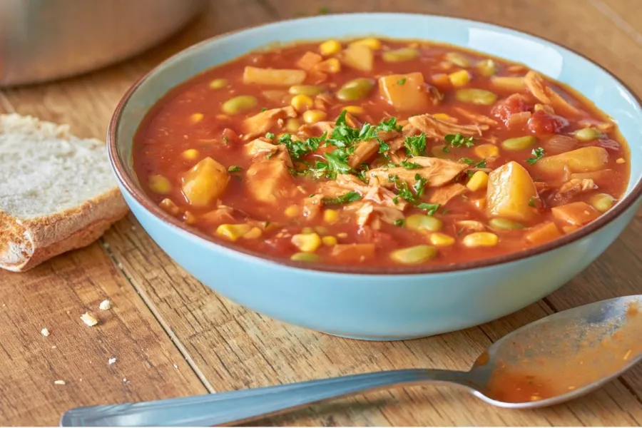 A deep palte with Brunswick stew.