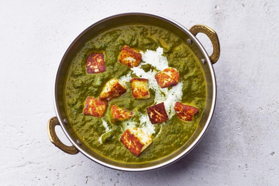 An individual pan with palak paneer.
