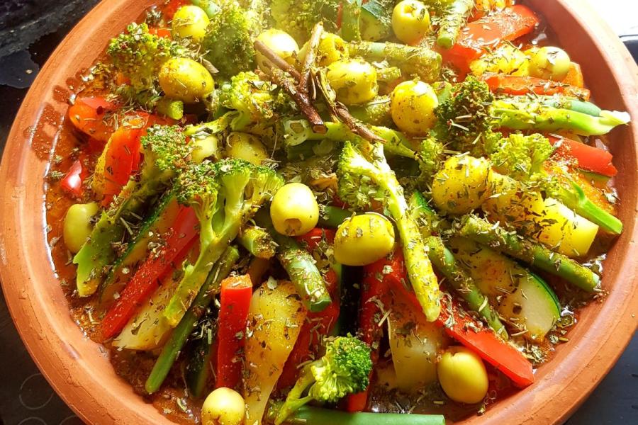 Vegetable tagine with chickpeas served on the base of a tagine, the traditional clay pot.
