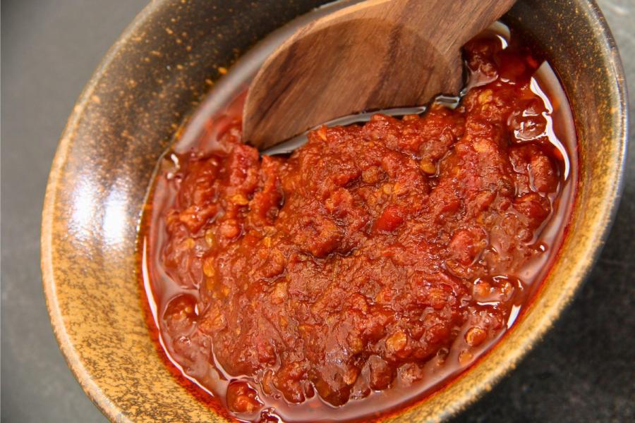 A ceramic bowl with sambal oelek.