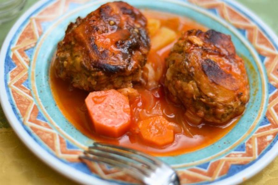 A plate of mafrum, a Libyan dish of vegetables stuffed with spiced ground meat and then simmered in a tomato-based sauce.