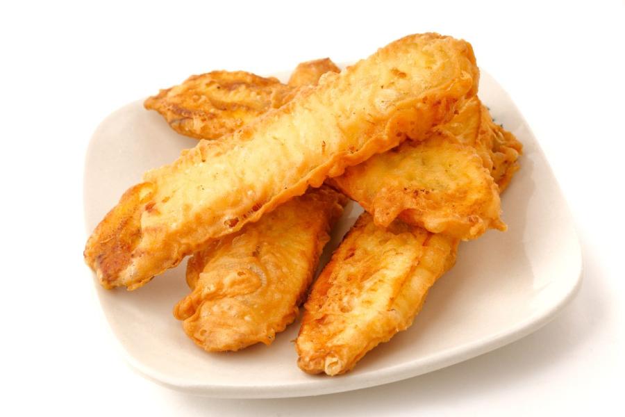 Plate of golden-brown fried plantain slices with a crispy batter coating, served on a white dish.