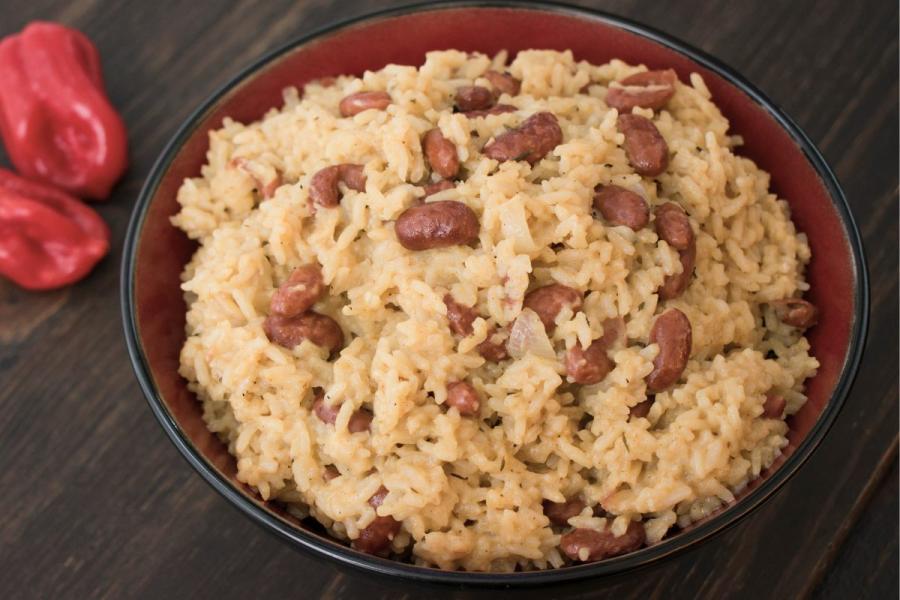 A erceipient with creamy rice and red beans, a traditional Caribbean dish.