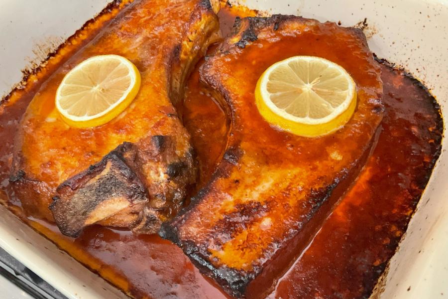 Two pork chops baked Bahamas style.