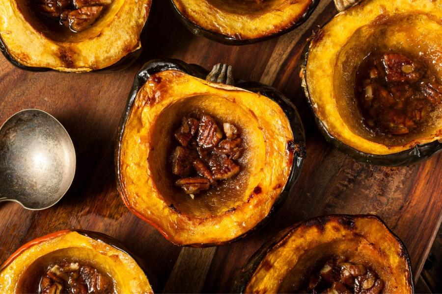 Roasted acorn squash halves filled with nuts and maple syrup.