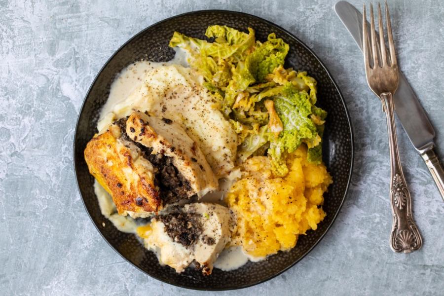 A plate of chicken Balmoral with cabbage, neeps and tatties.