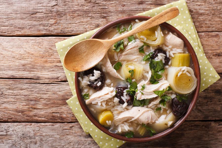 A bowl of hearty cock-a-leekie soup with chicken, leeks, rice and prunes.