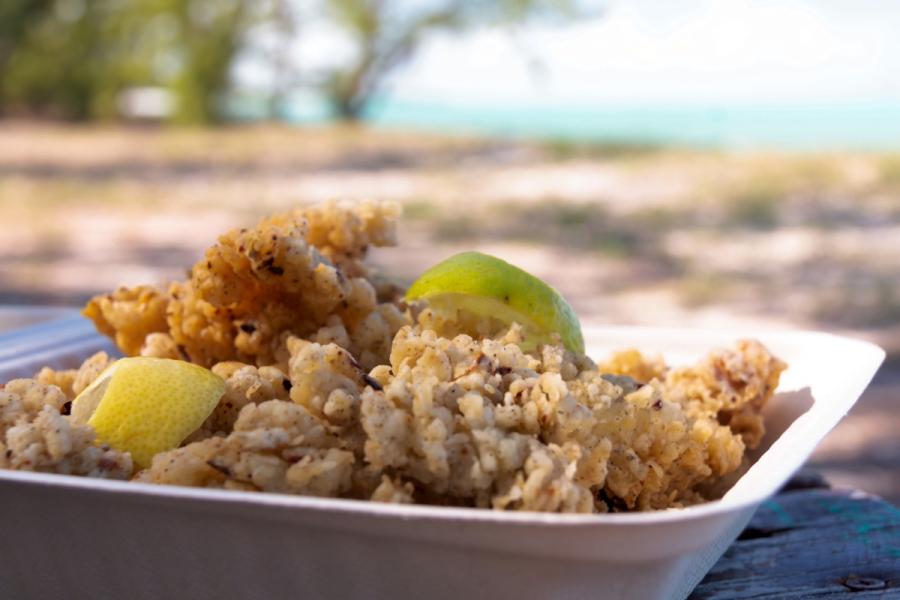A container filled with cracked conch, a tasty seafood dish.