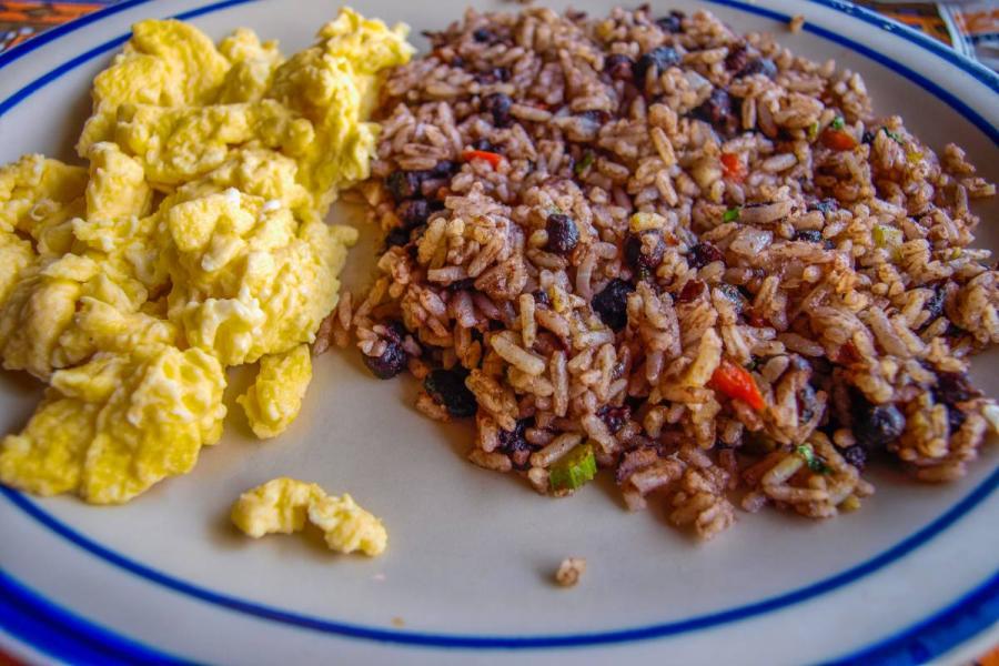 Costa Rican breakfast of gallo pinto with black beans and rice served with scrambled eggs.