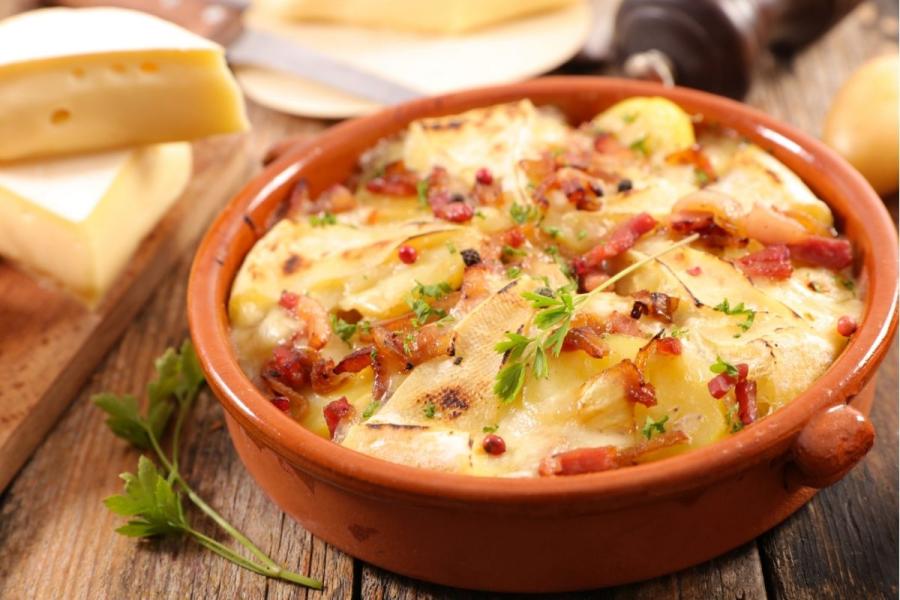Tartiflette in earthenware pan.