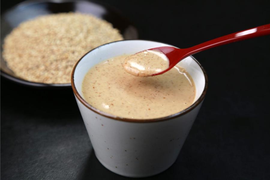 A small bowl with Japanese sesame sauce.
