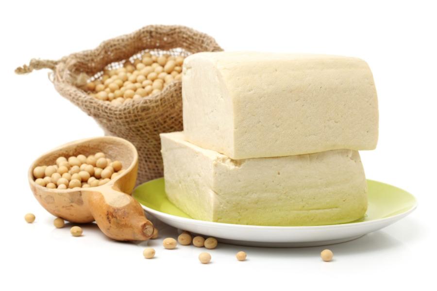 Two blocks of cold tofu and soy beans on the side.