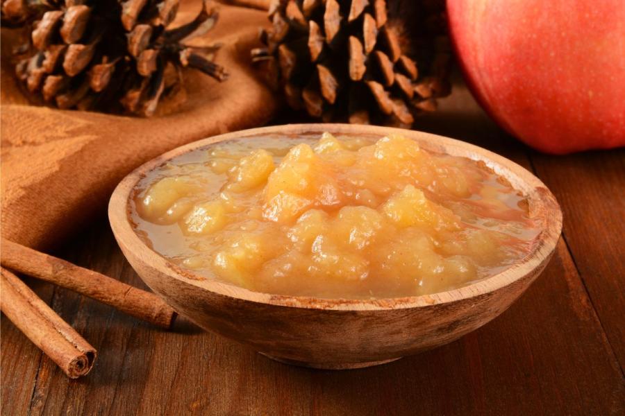 Dark apple sauce prepared with brown sugar and cinnamon.