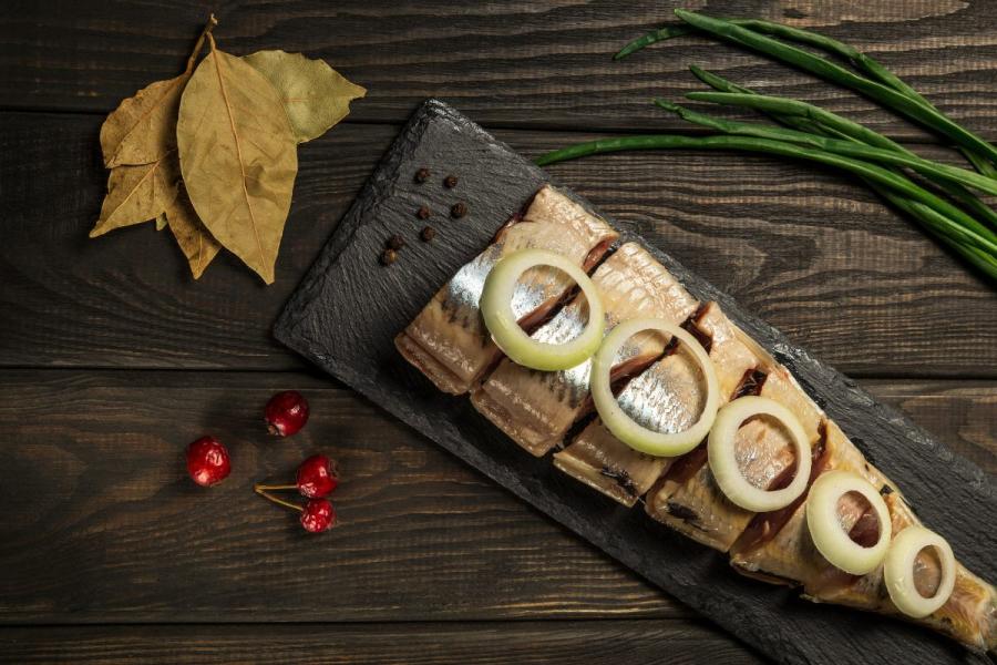Dutch raw herring served with onion and spices.