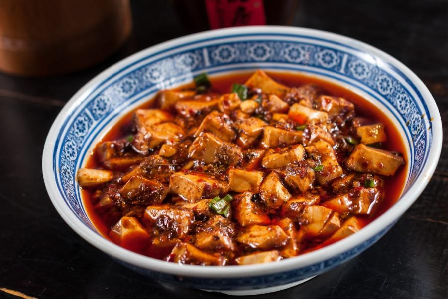 A ceramic bowl with mapo tofu.