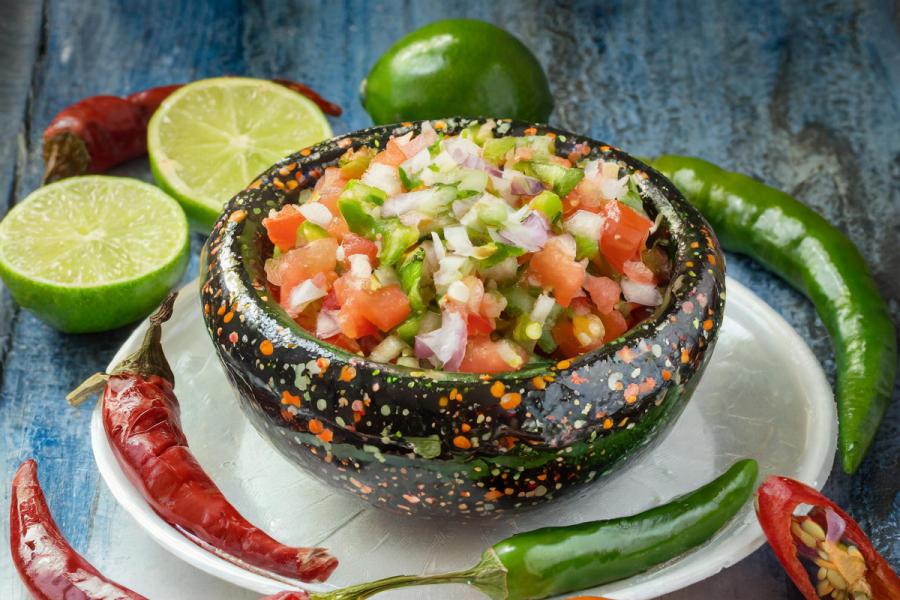 A coloful bowl with five alarm salsa cruda, a Mexican salsa with plenty of chili pepper.